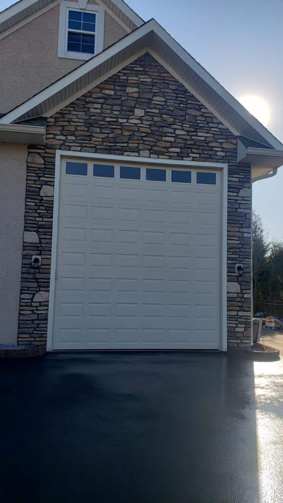 Finished stone veneer garage exterior